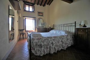 a bedroom with a bed and a table and a window at La Terrazza sulla Val d'Orcia in Castiglione dʼOrcia