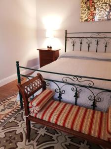 a bedroom with a bed with a bench next to it at Belle Époque in Taranto