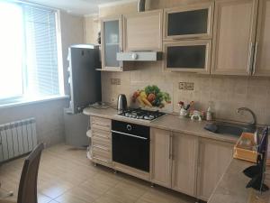 a kitchen with a sink and a stove top oven at Квартира в Тирасполе in Tiraspol