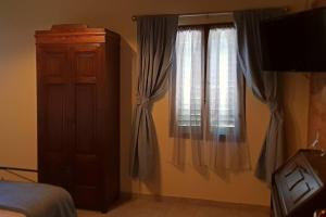 A bed or beds in a room at Il Cantuccio nel Chianti