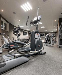 a gym with two exercise bikes and a treadmill at Rezidence Moser Apartments in Karlovy Vary