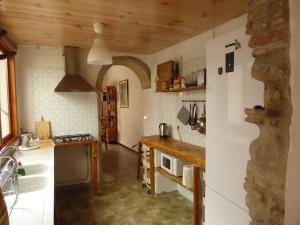 a kitchen with a white refrigerator and a counter at Casa de Cáliz Xàtiva in Xàtiva