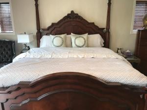 
a bed with two pillows on top of it at Royalty B&B in Richmond
