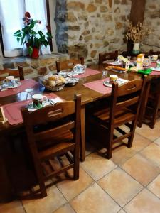 a wooden table with chairs and food on it at Casa Rural Irigoien in Donostia-San Sebastián +24 photos