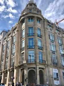 a large building with people standing in front of it at Oporto Chic&Cozy - Aliados in Porto +10 photos