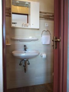 a bathroom with a sink and a mirror at Soba Željka in Bribir