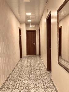 a hallway with a mirror and a hallway with a walkway at Ashel Hotel in Beer Sheva
