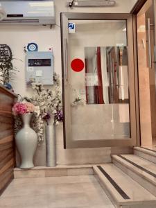 a store front with a vase with flowers in it at Ashel Hotel in Beer Sheva