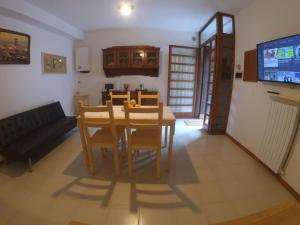a living room with a table and chairs and a tv at La Casa del Campanile in Summonte