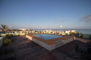a swimming pool on the roof of a building at Hotel Plaza Cozumel in Cozumel