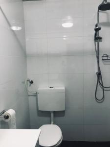 a bathroom with a toilet and a shower stall at Ashel Hotel in Beer Sheva