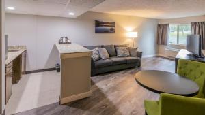 a living room with a couch and a table at Rocky Mountain Hotel & Conference Center in Estes Park