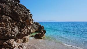 a rocky beach with the ocean in the background at Ria mare in Qeparo