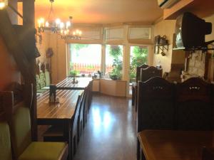 a dining room with a wooden table and chairs at Kiskakas Étterem in Zalaegerszeg +22 photos