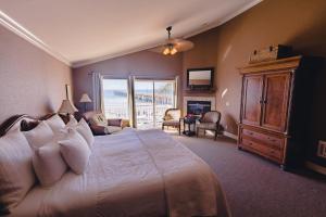 a bedroom with a large bed and a balcony at On the Beach Bed and Breakfast in Cayucos