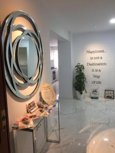 a mirror on a wall in a room with a table at Málaga Beauty Home in Málaga