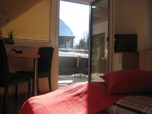 a bedroom with a bed and a sliding glass door at Appartement Alpenglühn in Oetz