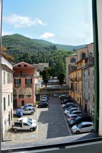 a city with cars parked in a parking lot at Ciassa Noeva in Pieve di Teco