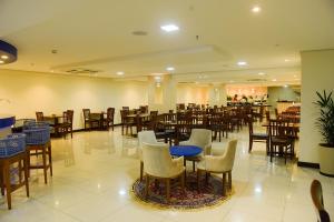 a dining room with tables and chairs in a restaurant at Best Hotel Sobral in Sobral