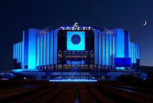 a large building is lit up blue at night at VITOSHKA Pleasure place in Sofia