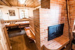 a brick fireplace in a living room with a table at Sleme house in Krška Vas