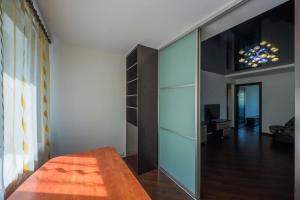 a large mirror in a room with a living room at Flat on Dneprovsky boulevard in Mogilev