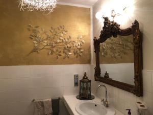 a bathroom with a sink and a mirror at Villa Miriam in Levico Terme +47 photos