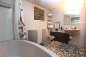 a bathroom with a tub and a sink and a toilet at The Bridge-House Apartment in Nicosia