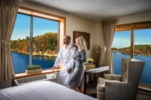 a man and woman standing in a hotel room with a window at The VUE Boutique Hotel & Boathouse in Wisconsin Dells