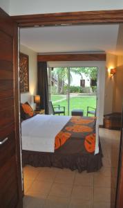 a bedroom with a bed and a large window at ROYAL BORA BORA in Bora Bora