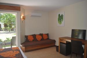 a living room with a couch and a table at ROYAL BORA BORA in Bora Bora