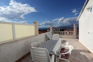 a patio with a table and chairs on a balcony at Apartments Aldica - 300 m from sea in Supetar