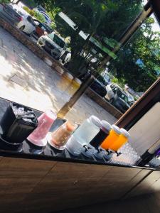 a counter with food and drinks on a window at Residence em Muro Alto Porto de Galinhas in Porto De Galinhas