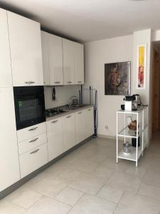 a white kitchen with white cabinets and appliances at Villa Jobè in Polignano a Mare