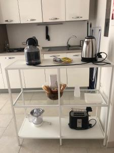 a white counter top with appliances on it in a kitchen at Villa Jobè in Polignano a Mare