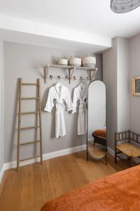 Cette chambre comprend une étagère avec des chemises et une échelle. dans l'établissement Superior Stays Luxury Apartments - Bath City Centre, à Bath