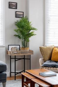 a living room with a table with a plant on it at Superior Stays Luxury Apartments - Bath City Centre in Bath
