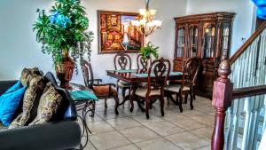 a dining room with a table and chairs at Mediterranean Three Story Beach Townhouse in St Pete Beach