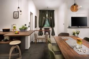 a dining room with a table and a television at Apartment Altana with free parking in Pula