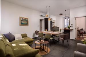 a living room with a couch and a table at Apartment Altana with free parking in Pula