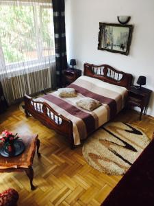 a bedroom with a large bed and a rug at Rolling Stone Hostel in Braşov