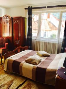a bedroom with a bed and a window at Rolling Stone Hostel in Braşov
