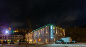 a building with cars parked in a parking lot at night at Hotel Miletto in San Massimo