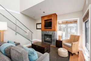 a living room with a couch and a fireplace at Cox Bay Beach Resort in Tofino