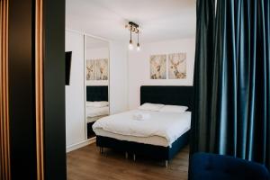 a bedroom with a bed and a mirror at ZEN Central Apartments in Cluj-Napoca