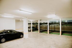 a garage with a car parked in it at ZEN Central Apartments in Cluj-Napoca +164 photos
