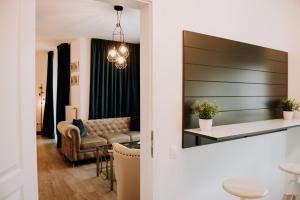 a living room with a couch and a table at ZEN Central Apartments in Cluj-Napoca