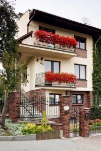 a house with red flowers on the balconies at Villa Gardena in Gdynia