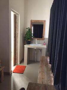 a bathroom with a sink and a mirror and a sink at Laksmi Guest House in Canggu