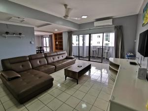 a living room with a couch and a table at 5 Bedrooms Penthouse 3 Bedrooms Apartment Marina Court Resort Condominium in Kota Kinabalu